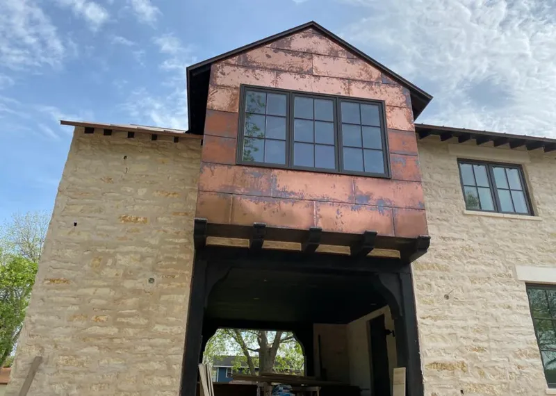Copper metal panel facade on a stone building for Skylight Installation in Fridley