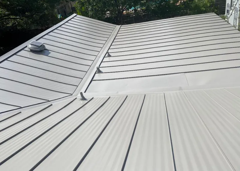 Solar attic fan installed on a metal roof for Roof Ventilation in Fridley